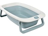 a close up of a bath tub with a blue and white tray