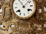 a gold clock that is sitting on a table