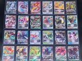 a close up of a collection of pokemon cards on a table