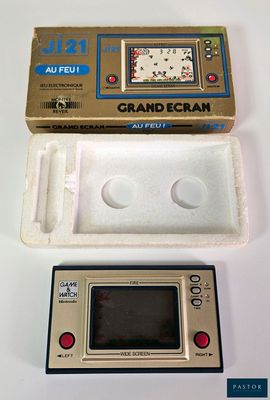 a small electronic device sitting on a table next to a box