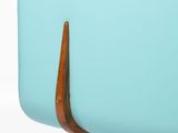 a blue couch with wooden legs and a wooden top