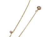 a close up of a pair of gold chains on a white background