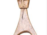 wooden figurine of a man with a hat on his head