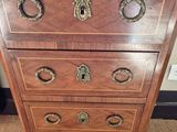 a wooden chest of drawers with brass knobs on it