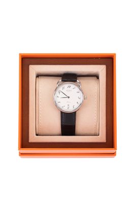 an orange box with a watch inside of it on a white background