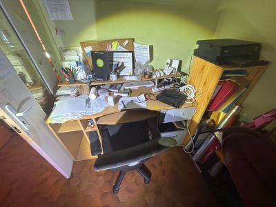 a desk with a chair and a computer on it