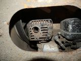 a dirty engine in the middle of a hole