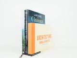 two books are stacked on top of each other on a white surface