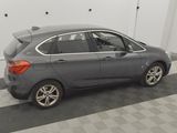 a picture of a grey car parked in a garage