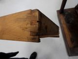 a person standing next to a piece of wood on the floor