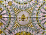 a pink and gold ceiling with gold decorations on it