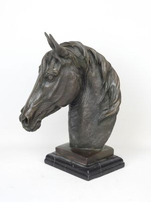 statue of a horse ' s head on a marble base