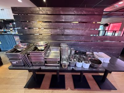 many pans and pans on a table in a restaurant