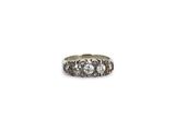 a close up of a ring with three diamonds on a white background