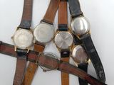 several different types of watches are displayed on a white surface