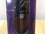 a purple box with a black bear in it on a wooden table