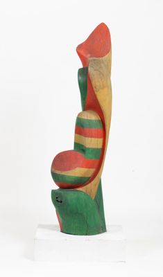 sculpture of a bird made of wood on a white surface