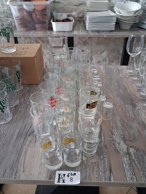 bottles and glasses on a table with a price tag on it