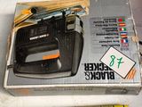 two boxes of power tools sitting on a table