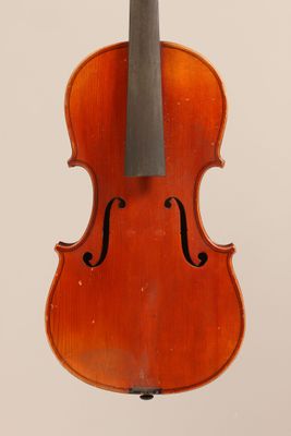 an old violin with a bow hanging from it ' s back