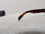 a pair of glasses sitting on a bed next to a mouse