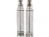 a pair of silver metal earrings with chains hanging from them