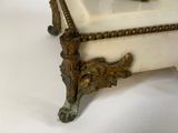 an antique bronze figurine of a woman on a marble box