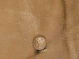 a close up of a piece of cloth with a coin on it