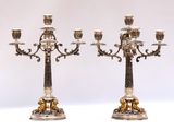 pair of antique silver plated candelabs with lions on them