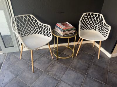 two chairs sitting next to each other on a tiled floor