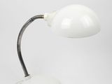 a close up of a white table lamp on a white surface