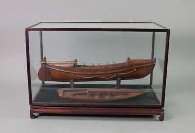 a wooden model of a boat in a glass case