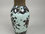 a vase that is sitting on a white surface