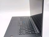 a laptop with a black keyboard on a white surface