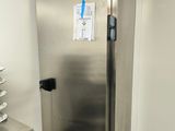 a stainless steel refrigerator in the corner of a kitchen