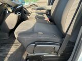 a seat in the back of a car with a suitcase in it