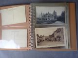 an old photo album with a lot of postcards on it