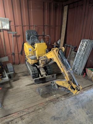 a yellow bulldozer that is parked in a garage