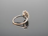 a close up of a ring with a flower on it