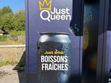 a vending machine that has a can of beer on it