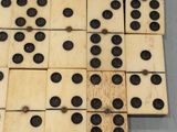 several pieces of wooden domino board with black dots on them