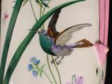 a vase with a bird painted on the side of it