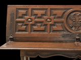 a wooden bench that has a carved design on it
