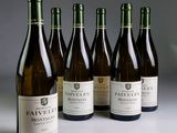 six bottles of wine are lined up on a table