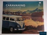 an image of a blue and white vw bus parked next to a lake