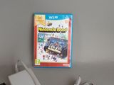 a nintendo wii game sitting on a table next to a charger