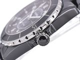 a watch that is sitting on a black bracelet