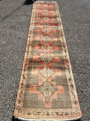 an old runner rug is laying on the pavement
