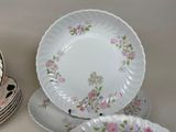 many plates and cups sitting on a table
