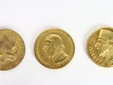 three gold coins with a picture of a man and a woman on them